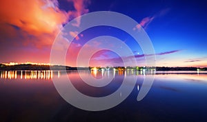 Night landscape on the lake with blue sky and clouds