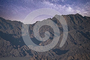 Night landscape, mountain range, rocks, stone peaks against the background of the night sky with stars and the Milky Way, Sinai