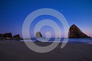 Night landscape on the Pacific Ocean, with a landscape but a starry sky. Cannon Beach