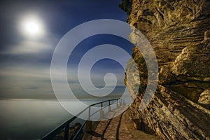 Night landscape with the sea, the moon and rocks