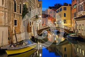 Night lateral canal and bridge in Venice, Italy photo