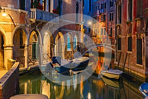 Night lateral canal and bridge in Venice, Italy photo
