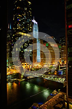 Night life on Chicago ship canals with bridge and skyscrapers