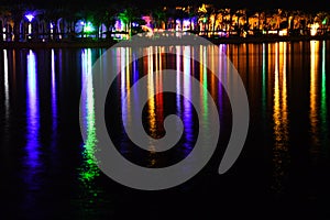 Night lightning and shining beach with colorful lights and beautiful long reflection