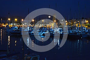 Picturesque Mediterranean port before dawn, moon sinking