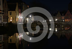 Night lights and bridge on canal in Bruges