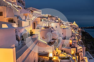 Night lights after sunset at Santorini island, Greece. White architecture in Fira town