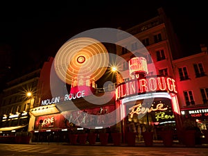 Night long exposure of Moulin Rouge concerts club entertainment cabaret Pigalle Montmartre Paris France Europe