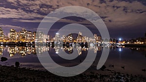 A night long exposure photo of marina inside Burrard Inlet of Vancouver Harbor with many yachts and boats