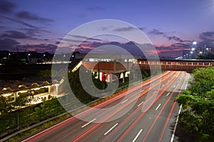 The night in metropolis, train station and vehicles in transit. Sao Paulo city highway beside the river. Skyline, cars and