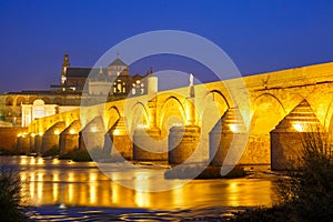 Night Mezquita and Roman bridge in Cordoba, Spain photo