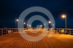 night molo pier with lantern yellow light at Polish village Jastarnia