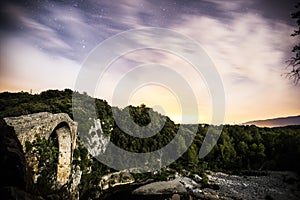 Night and moonlight in Sant Jaume De Llierca roman bridge, La Garrotxa, Spain