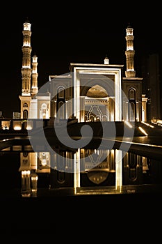 Night mosque reflection on the water