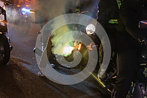 Night motorcycle parade with torches in the fog