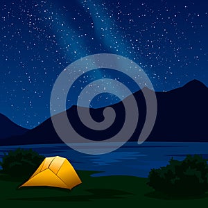 Night mountain landscape with illuminated orange tent and Milky Way.