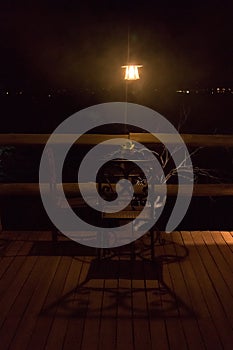 Night and mystic atmosphere with lamp and wooden table.