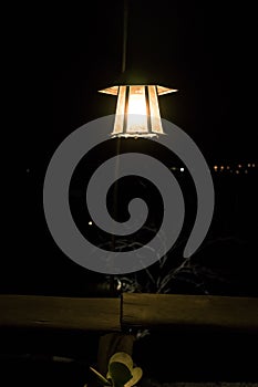 Night and mystic atmosphere with lamp and wooden table.