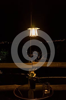 Night and mystic atmosphere with lamp and wooden table.