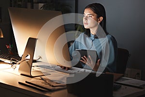 Night office, computer and business woman with tablet for digital marketing, seo analytics and multimedia application