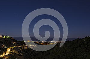 Night panorama above quiet touristic town on mediteranean shore