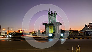 night panorama of the city of Kupang decorated with the historical monument of three heroes