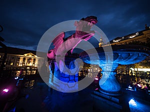 Night panorama of Neuer Platz square water fountain Lindwurmbrunnen lindworm dragon in Klagenfurt Carinthia Austria