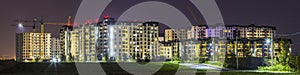 Night panorama of new built and still under construction apartment buildings