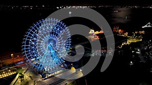Night panoramic landscape of illuminated ferris wheel at Rio de Janeiro Brazil