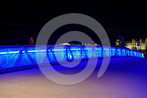 Night photo of a blue neon bridge with cracked glass Oslo Norway