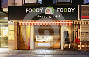 Night photo of a fast food store with the funny name of Foody Foody in Germany.