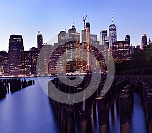 Night photo of glowing skyscrapers and a view of Manhattan Bay. Long duration. Vertical panorama.