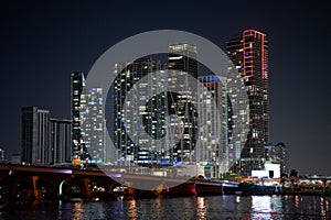 Night photo highrise condos Downtown Miami with bridge and bay