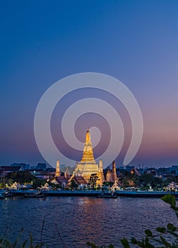 Night photo illuminated old Wat Arun Ratchawararam Ratchawaramahawihan or Wat Arun