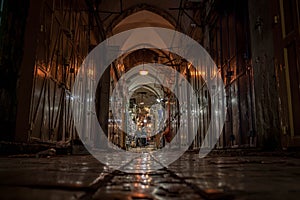 The night photo of the market alley with open and closed shopes in Jerusalem Old Town, Israel.