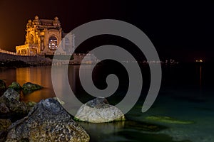 Night photo old casino on the black sea shore in constanta city, romania