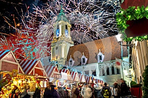 Main sqaure at night in Bratislava, Slovakia during Christmas market time with big fireworks at the back