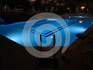 Night pool side of rich hotel trademarks were removed