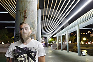 Night portrait of a street bearded man drug seller gang member bandit