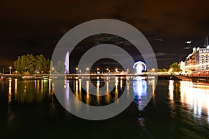 Night riverside view with beautiful reflections of Geneva city, Switzerland