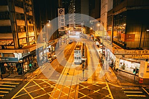 Night road at Central district Hong Kong city street view with traditional style tram public transport