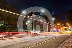 The night road in the city with light trails of traffic.