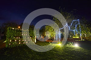 Night rustic wedding decoration, outdoor event with lightstrings