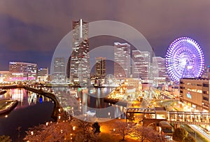 Night scape of Minatomirai Bay Area in Yokohama, Japan, with Landmark Tower amid high rise buildings in background