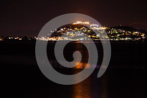 Night scene of Astros town with old castle Greece photo