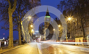 Night scene of Big Ben and London city street with car trails of light