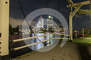 Night scene with drawbridge at Amstel river in Amsterdam