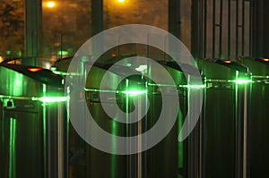 Night scene with four turnstiles with green led lighting