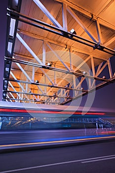 Night scene with illuminated pedestrian bridge and traffic in motion blur, Beijing, China