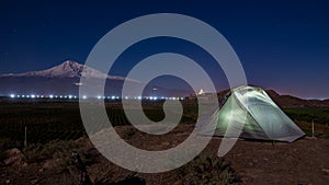 Night scene of illuminated tent and Mt. Ararat, Armenia